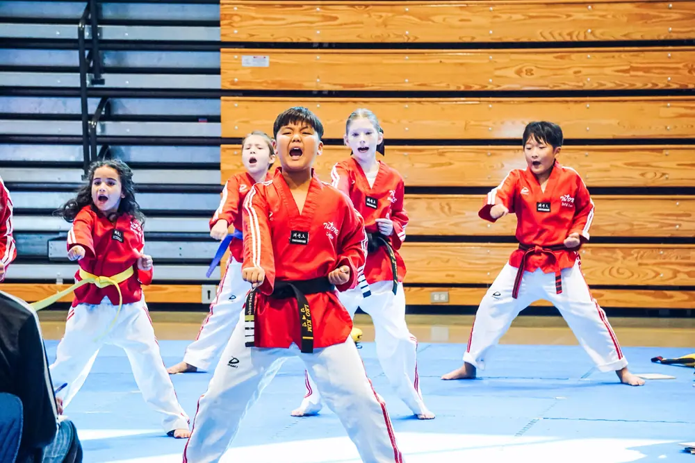 Students performing poomsae with spirit during the tournament