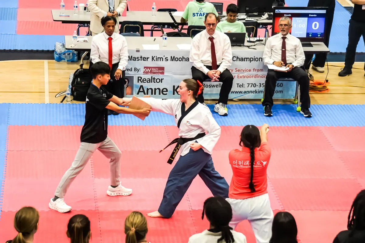 Black belt competitor breaking a board during the championship